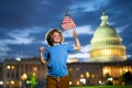 Child with American flag in Washington DC, capitol, congress building. American people celebrate 4th of July. American Royalty Free Stock Photo