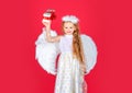 Child angel little girl with present gift, studio portrait. Little angel, happy fairy with white wings holds gift. Cute