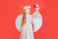 Child angel little girl with present gift, studio portrait. Little angel, happy fairy with white wings holds gift. Cute