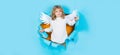 Child angel in paper hole. Portrait of angelic kid. Little cupid boy in white wings. Christmas kids. Royalty Free Stock Photo