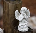 Child Angel statue on wooden post Royalty Free Stock Photo