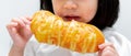 Child with anorexia concept. Little girl`s hand holding bread. White background