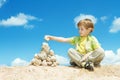 Child ans stones over blue sky Royalty Free Stock Photo