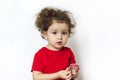 Child with appetite eats and studies candy. girl holding a lollipop in her hands