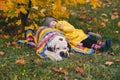 Child with apple having rest next to big dog