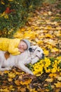 Child with apple having rest next to big dog