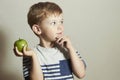 Child with apple.Little Handsome Boy with green apple. Health food. Fruits