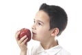 Child with apple looking upwards.