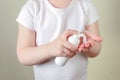Child applying foam sanitizer on her hands.