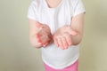 Child applying foam sanitizer on her hands.