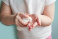 Child applying foam sanitizer on her hands