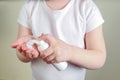 Child applying foam sanitizer on her hands