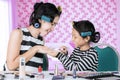 Child applying nail polish to her mother in bedroom Royalty Free Stock Photo