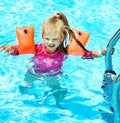 Child with armbands in swimming pool Royalty Free Stock Photo