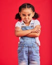 Child, arms crossed or angry portrait on isolated red background for tantrum face, behavior problem or stubborn. Mad