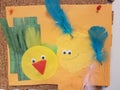 Child artwork of birds, yellow circles with feathers