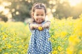 Child asian little girl holding flower in her hand in the garden Royalty Free Stock Photo