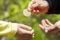 A child is asking for pocket money and her parent is giving a bitcoin coin in response Royalty Free Stock Photo