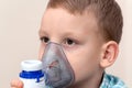 Child with asthma problems making inhalation with mask. Sick kid respiratory bronchitis. Treatment of pneumonia nebulizer