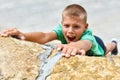 Child athlete falls off a cliff. danger of falling from a hill. climb a high mountain.