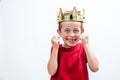 Child attitude with giggling young spoiled boy with a crown