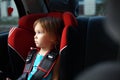 Child in auto baby seat in car