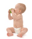 Child baby boy sitting in diaper and eating green apple Royalty Free Stock Photo