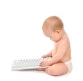 Child baby boy toddler sitting with hands typing on the remote Royalty Free Stock Photo