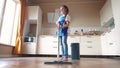 the child baby washed the floors. happy family kid dream concept. daughter washed the floors with a mop in the kitchen