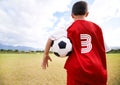 Child, back view and soccer player on field for practice, workout and ready for training on grass. Boy, athlete and ball Royalty Free Stock Photo