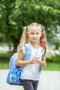 A child with a backpack and a bottle of water. The concept of school, study, education, friendship, childhood. Royalty Free Stock Photo