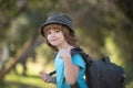 Child with backpack hiking in scenic mountains. Boy local tourist goes on a local hike.