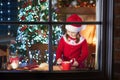 Child baking Christmas cookies. Kids bake for Xmas