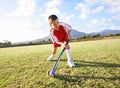 Child, ball and playing hockey on green grass for game, sports or outdoor practice match. Young kid or player enjoying