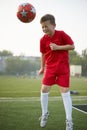 Child with Ball on the sport field. Football player