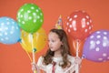 Child with balloons on his birthday.