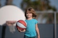 Child basketball. Kid boy concentrated on playing basket ball.