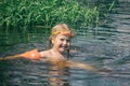 A child bathes in a summer river Royalty Free Stock Photo