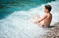 Child bathes waves surf Adriatik sea Lustica beach Zanjic Montenegro