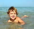 Child bathing in sea on beach