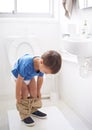 Child, bathroom and toilet training in diaper or learning growth, milestone or hygiene. Male person, kid and pants or Royalty Free Stock Photo