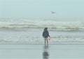 Child at the beach on a foggy day Royalty Free Stock Photo