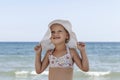 A child on the beach poses for the camera