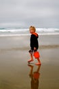 Child on Beach with Red Bucket Royalty Free Stock Photo