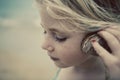 Child at Beach with Seashell Royalty Free Stock Photo