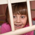 Child behind bars of the crib Royalty Free Stock Photo