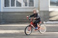 Child on a Bicycle on paved road. Boy learns to ride develoepd