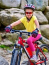 Child on bicycle ride mountain. Girl traveling in summer park. Royalty Free Stock Photo