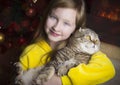 A child with a big cat near the fireplace Royalty Free Stock Photo