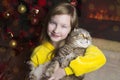 A child with a big cat near the fireplace Royalty Free Stock Photo